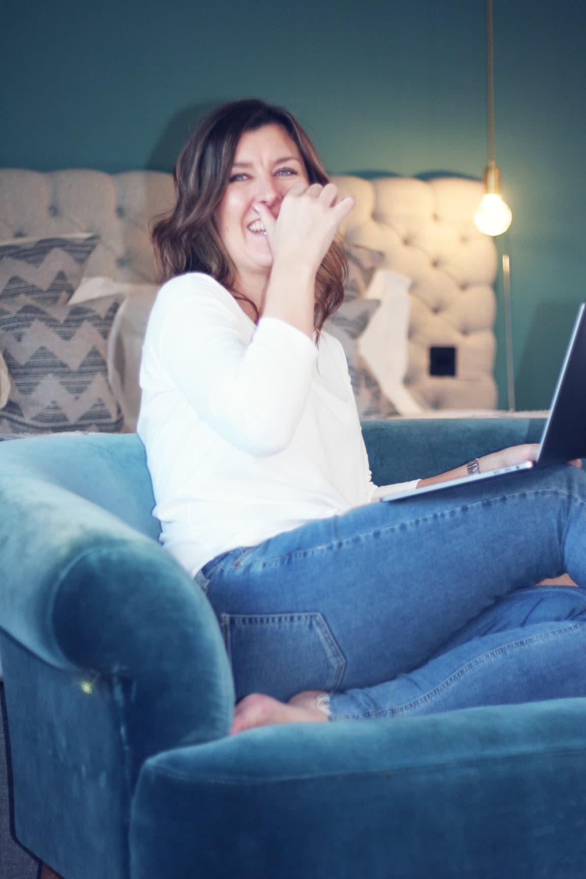 Nicole smiling while seated with a laptop